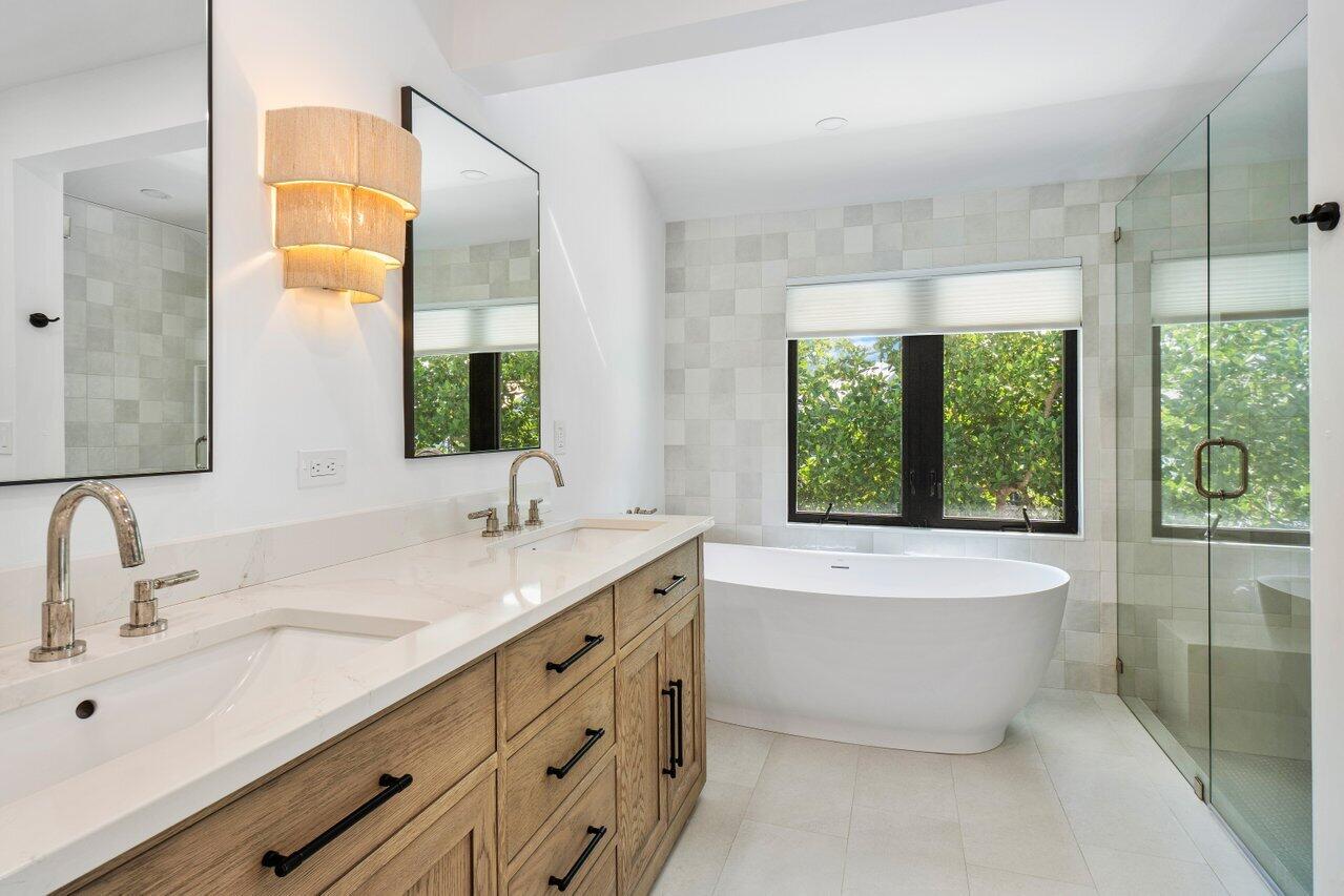 720 Mariners Way Boynton Beach, FL 33435 - Photo 27 of 49 a bathroom with a double vanity sink bathtub and next to a window