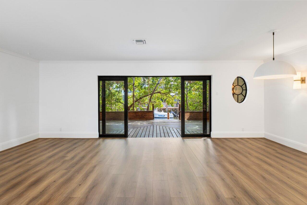 720 Mariners Way Boynton Beach, FL 33435 - Photo 5 of 49 a view of empty room with wooden floor and fan