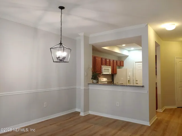 a front view of a building with street view and trees