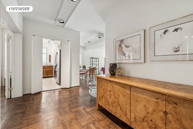 a dining room with furniture and a potted plant