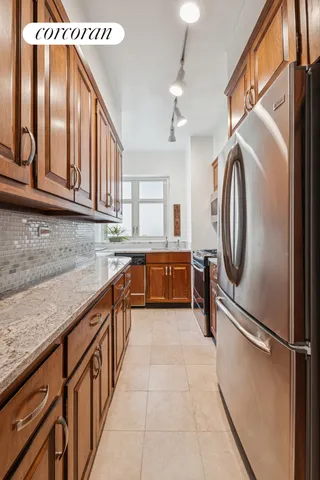 a large white kitchen with wooden floor