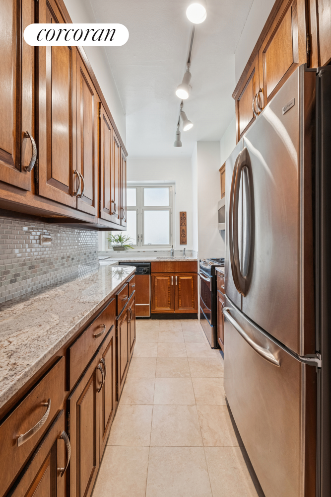 36 Sutton Place South, Unit 11A Manhattan, NY 10022 - Photo 4 of 8 a kitchen with stainless steel appliances granite countertop a refrigerator and a sink