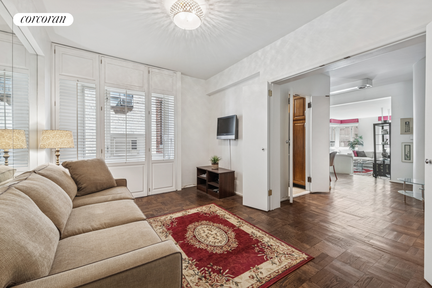 36 Sutton Place South, Unit 11A Manhattan, NY 10022 - Photo 6 of 8 a living room with furniture and a large window