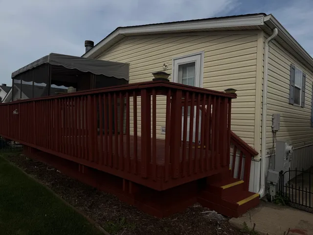 a view of backyard with wooden fence and trees