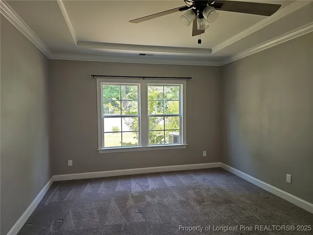 a view of a livingroom with a window and a ceiling fan