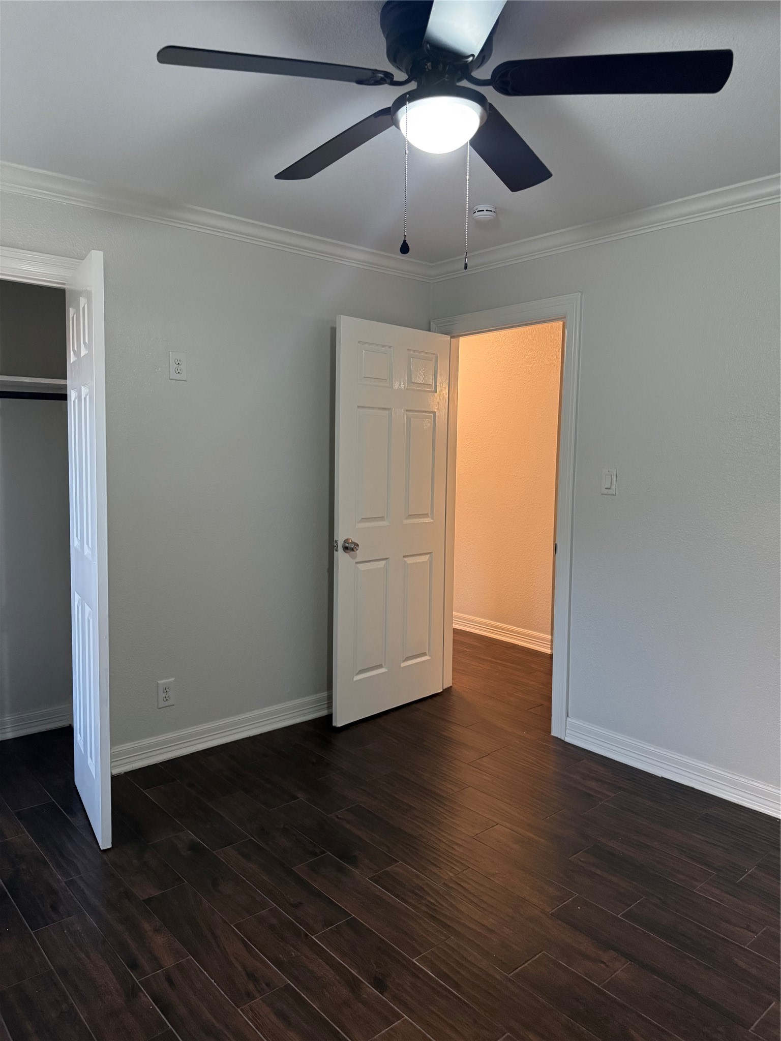 534 Sulphur Street Houston, TX 77034 - Photo 15 of 46 a view of an empty room with wooden floor and a ceiling fan