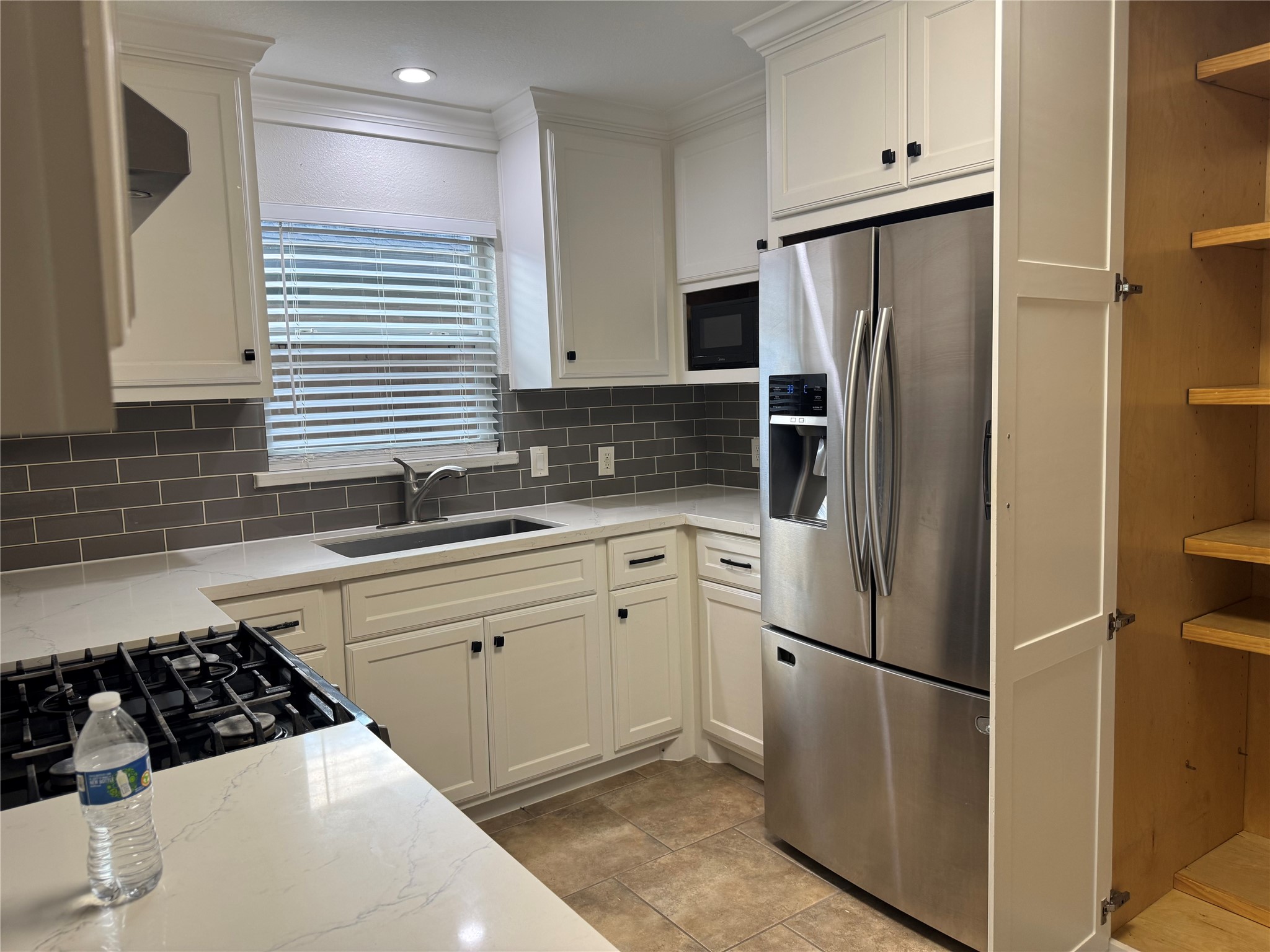 534 Sulphur Street Houston, TX 77034 - Photo 31 of 46 a kitchen with white cabinets and refrigerator