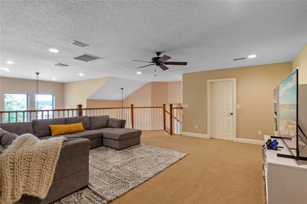 16940 Apopka Springs Boulevard Montverde, FL 34756 - Photo 15 of 36 a living room with furniture and a flat screen tv