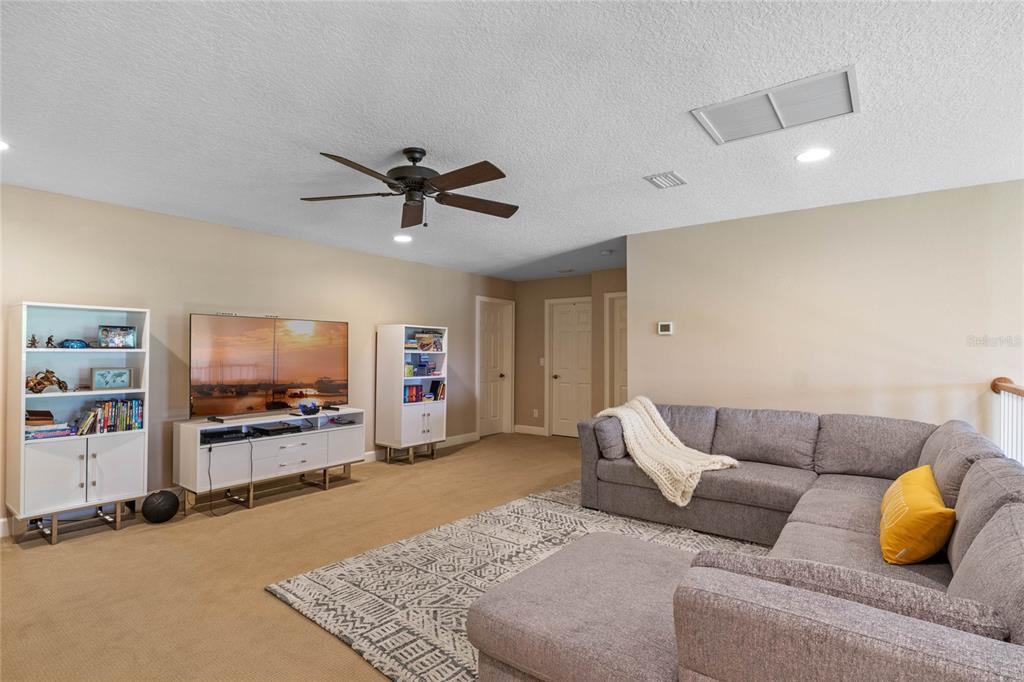 16940 Apopka Springs Boulevard Montverde, FL 34756 - Photo 16 of 36 a living room with furniture and a flat screen tv