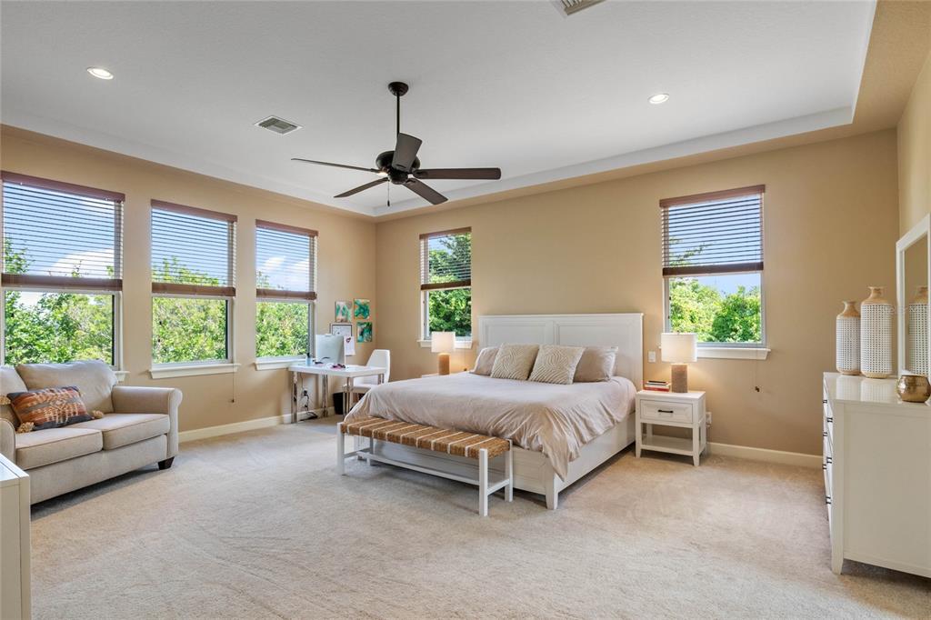 16940 Apopka Springs Boulevard Montverde, FL 34756 - Photo 17 of 36 a spacious bedroom with a bed couch and windows