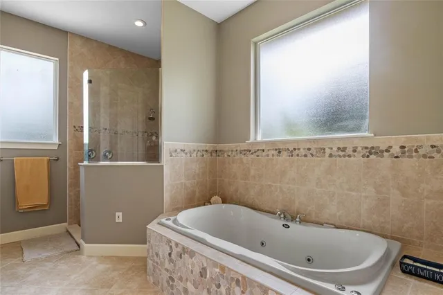a bathroom with a bathtub and window