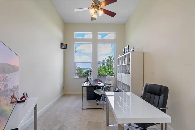 a view of a workspace with furniture and a window