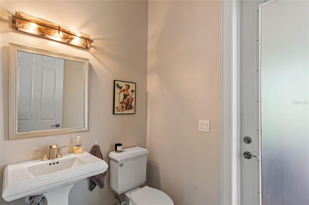 16940 Apopka Springs Boulevard Montverde, FL 34756 - Photo 22 of 36 a bathroom with a toilet a sink and mirror