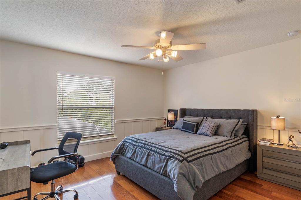 16940 Apopka Springs Boulevard Montverde, FL 34756 - Photo 25 of 36 a bedroom with a bed and a chandelier