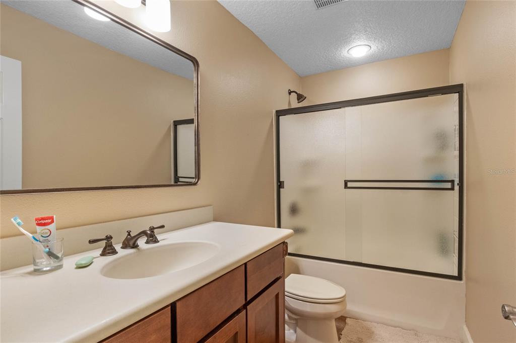 16940 Apopka Springs Boulevard Montverde, FL 34756 - Photo 28 of 36 a bathroom with a sink toilet and shower