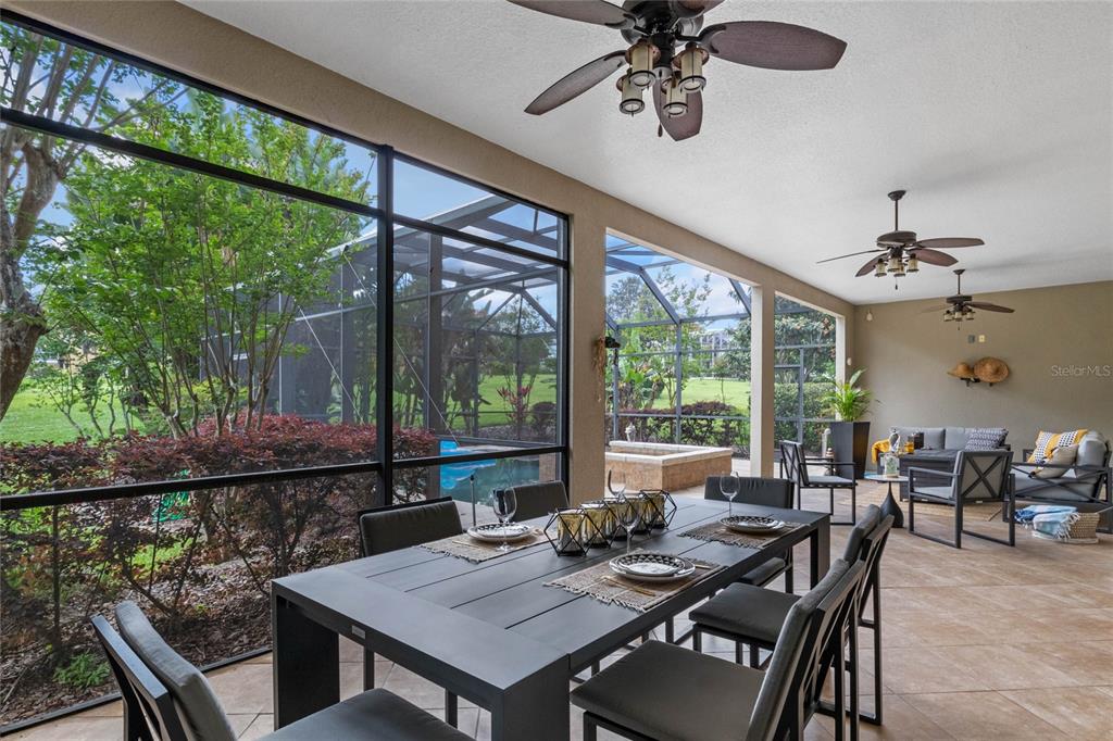 16940 Apopka Springs Boulevard Montverde, FL 34756 - Photo 30 of 36 a view of a patio with a table chairs and wooden floor