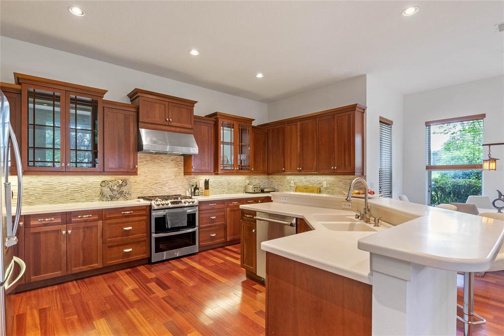 16940 Apopka Springs Boulevard Montverde, FL 34756 - Photo 6 of 36 a kitchen with a sink stove and cabinets