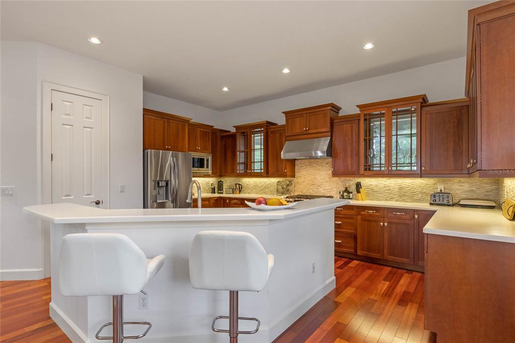 16940 Apopka Springs Boulevard Montverde, FL 34756 - Photo 7 of 36 a kitchen with stainless steel appliances granite countertop a sink wooden cabinets and a granite counter tops