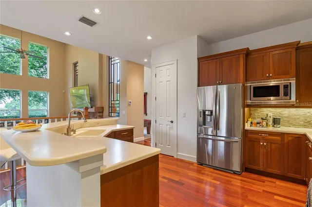 a kitchen with granite countertop a sink appliances and cabinets