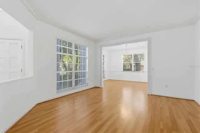 a kitchen with granite countertop a sink cabinets and wooden floor