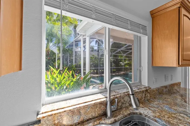a very nice looking room with a large window and chandelier