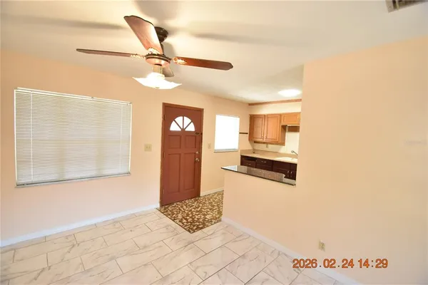 a kitchen with granite countertop a sink cabinets stainless steel appliances and a window