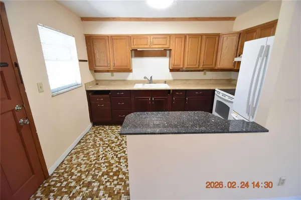a kitchen with a sink a stove and cabinets