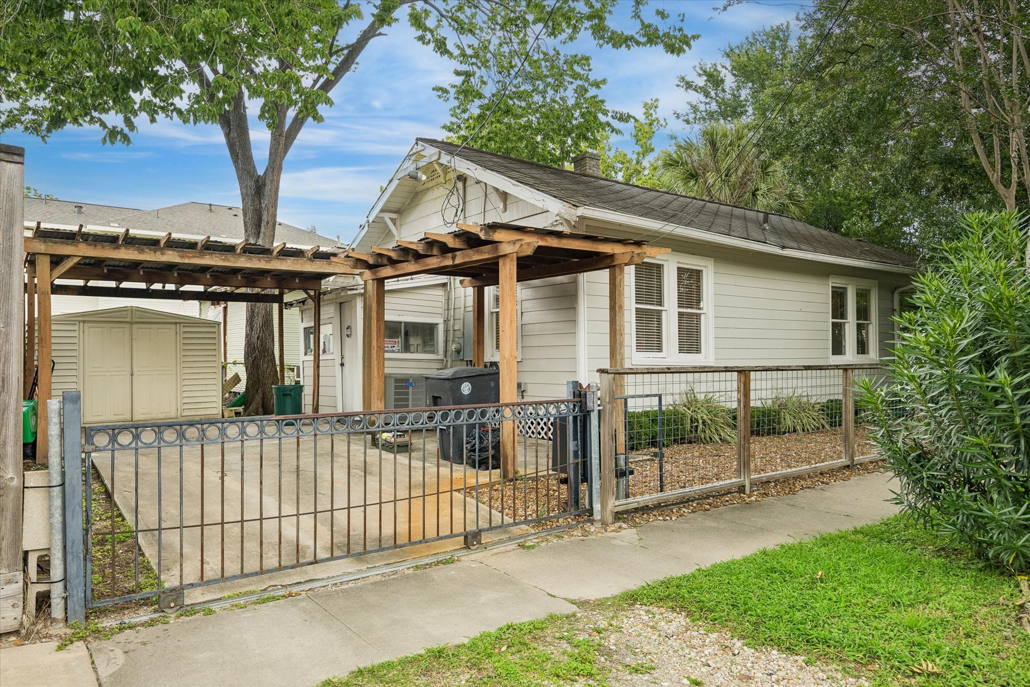 1201 Tulane Street Houston, TX 77008 - Photo 5 of 31 City living gets a major convenience boost with a gated driveway, covered parking, and a storage shed for tools, bikes, lawn gear, or weekend extras. It is the kind of practical outdoor setup that makes this Historic Heights home even easier to love.