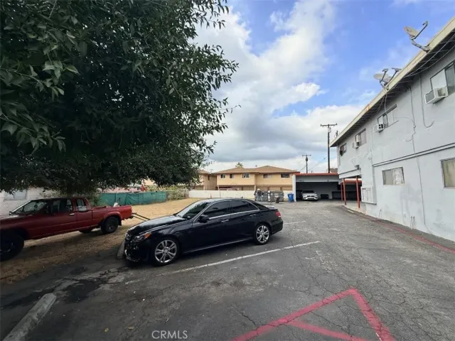 a view of cars parked on the side of a street