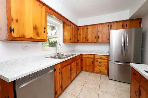 a kitchen with stainless steel appliances granite countertop a sink and cabinets