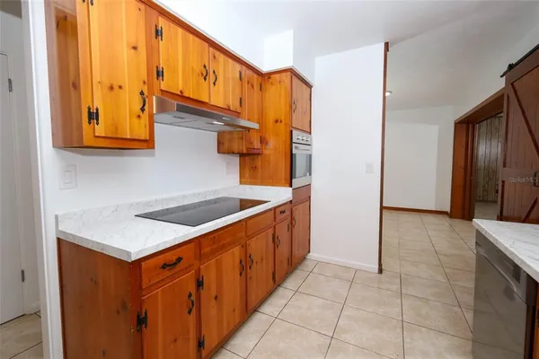 a kitchen with stainless steel appliances a sink and cabinets