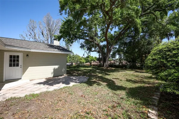 a view of a house with a tree in the background