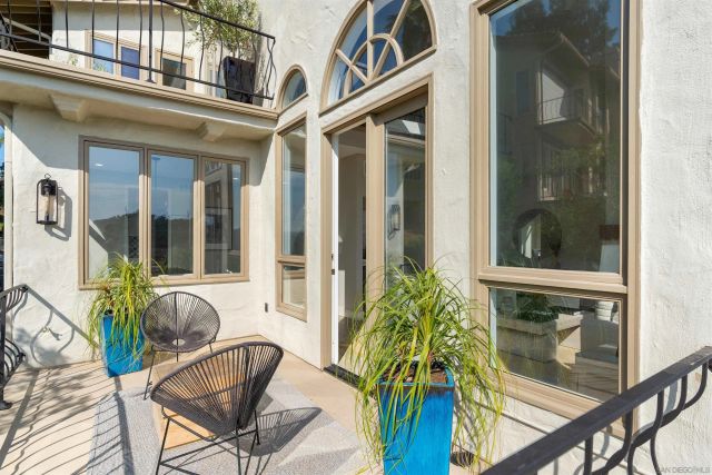 a view of a balcony with wooden floor and fence