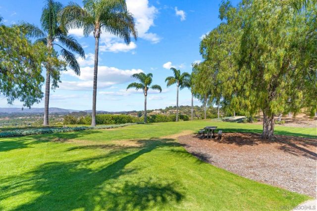 a view of house with swimming pool and sitting area
