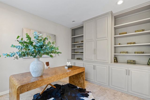 a living room with furniture a fireplace and a large window