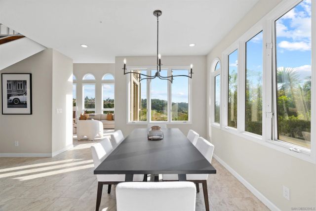 a view of a dining room with furniture large windows and wooden floor