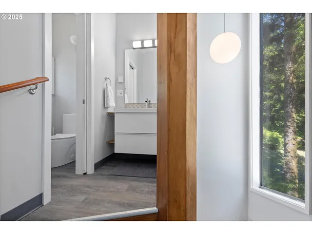 a view of a bathroom with sink mirror and window