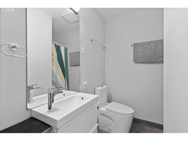 a bathroom with a sink a toilet and a mirror