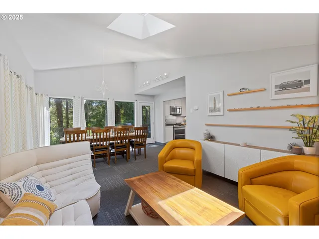 a bedroom with furniture and a large window