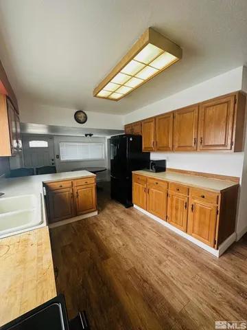 a kitchen with a sink appliances and cabinets