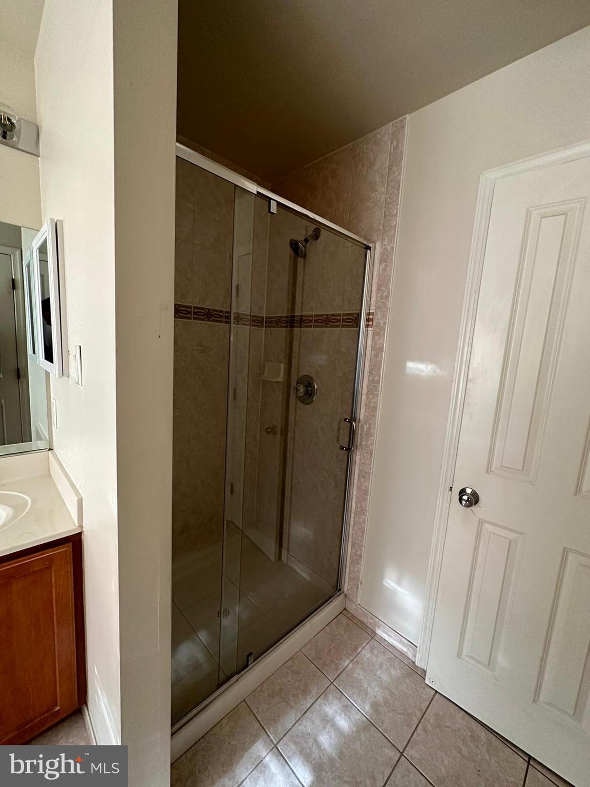 5409 Commerce Row, Unit 49 Bowie, MD 20720 - Photo 16 of 22 a bathroom with a glass shower door