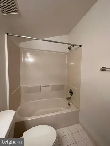 a bathroom with a toilet and a bath tub