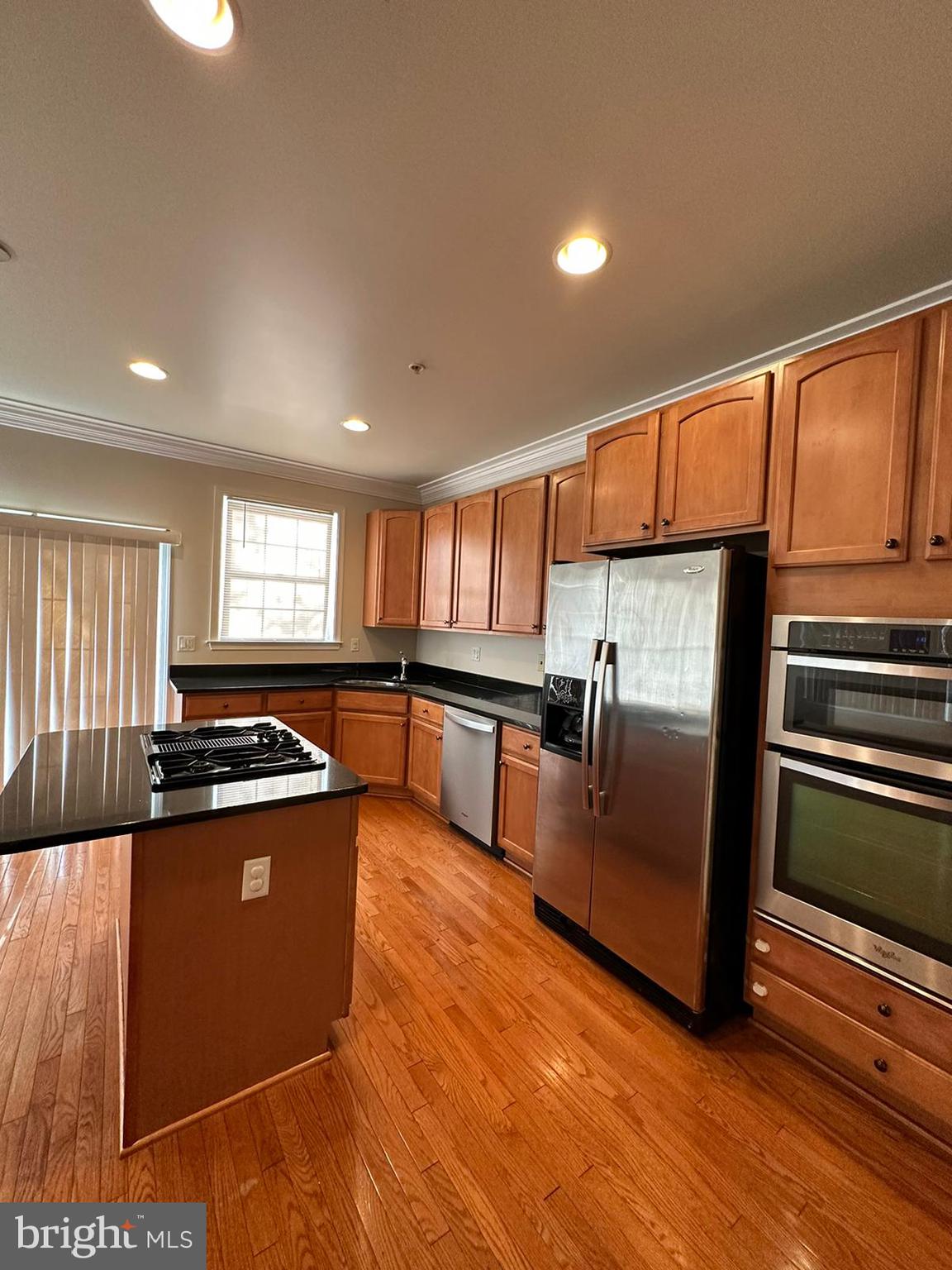 5409 Commerce Row, Unit 49 Bowie, MD 20720 - Photo 7 of 22 a kitchen with stainless steel appliances granite countertop a stove a sink and a refrigerator