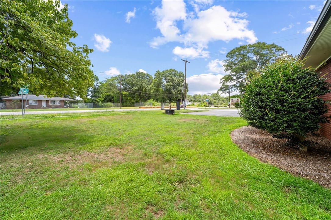 212 East Shockley Ferry Road Anderson, SC 29624 - Photo 4 of 28 A verdant, well-maintained lawn unfolds before a tranquil residential street.