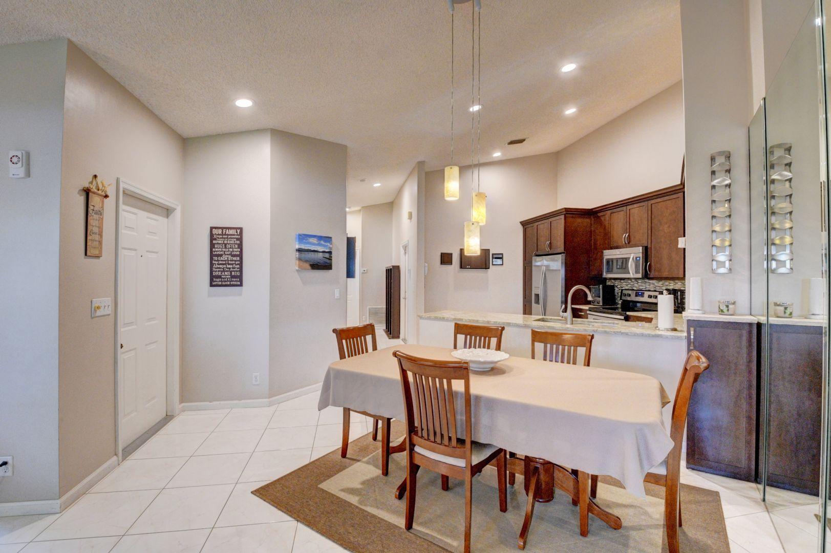 9238 Vineland Court, Unit G Boca Raton, FL 33496 - Photo 11 of 42 a view of a dining room with furniture