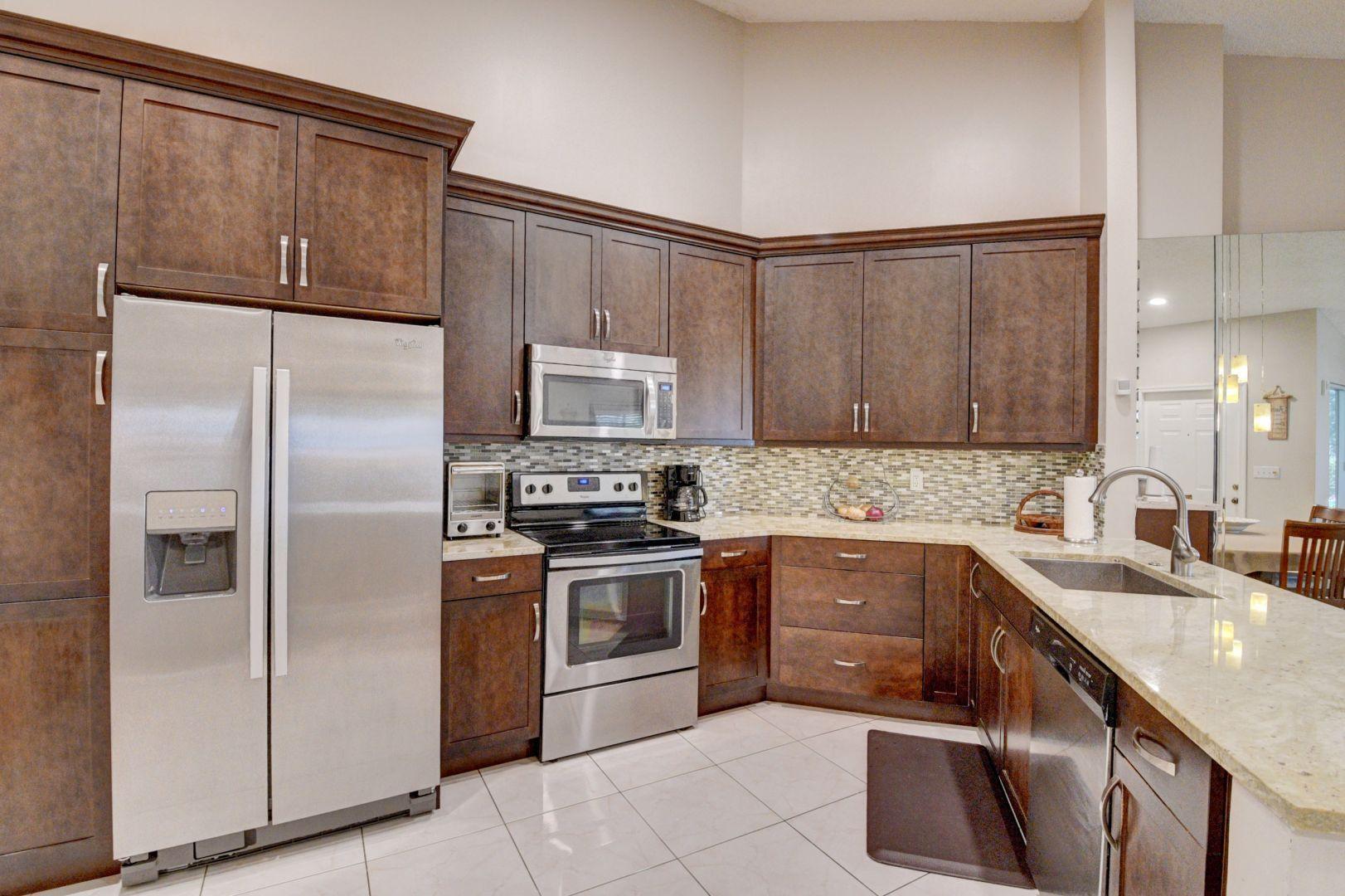 9238 Vineland Court, Unit G Boca Raton, FL 33496 - Photo 14 of 42 a kitchen with a sink appliances and cabinets