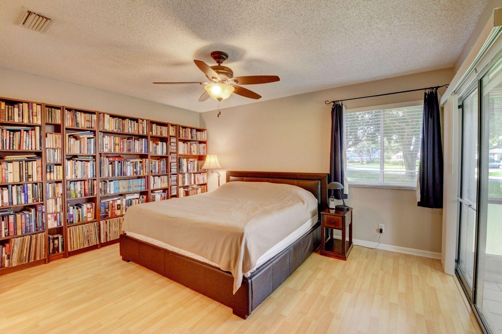 9238 Vineland Court, Unit G Boca Raton, FL 33496 - Photo 18 of 42 a bed sitting in a bedroom next to a window