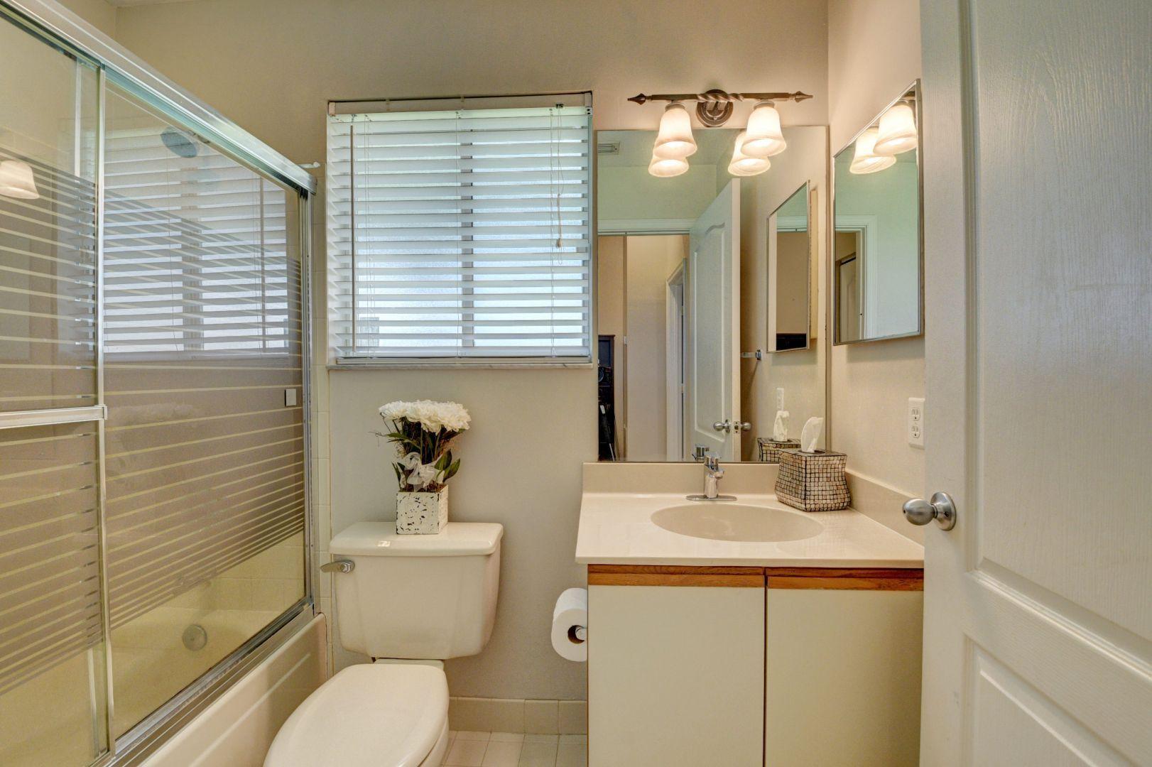 9238 Vineland Court, Unit G Boca Raton, FL 33496 - Photo 22 of 42 a bathroom with a sink a toilet and shower