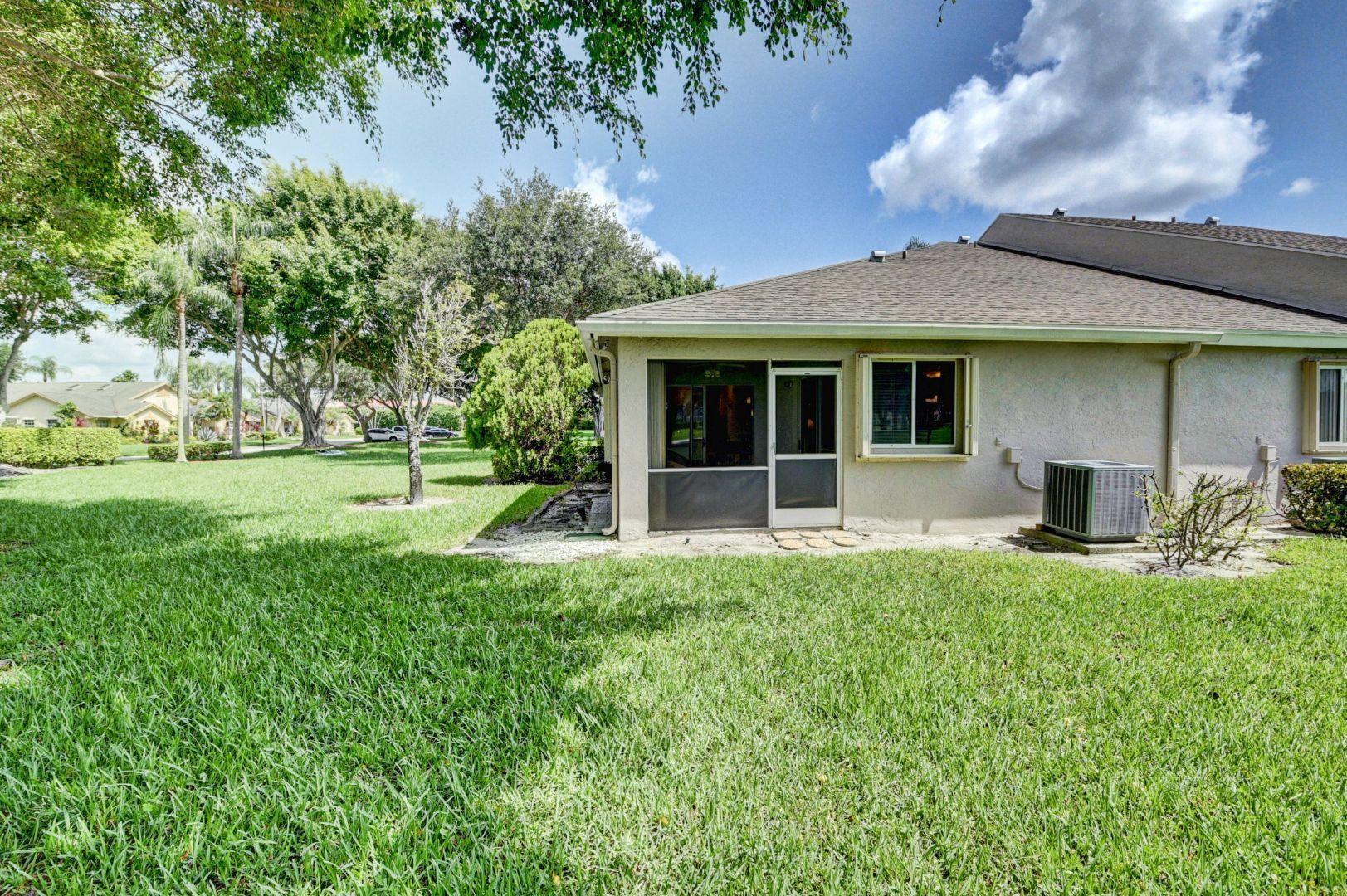 9238 Vineland Court, Unit G Boca Raton, FL 33496 - Photo 25 of 42 a view of a house with yard and sitting area