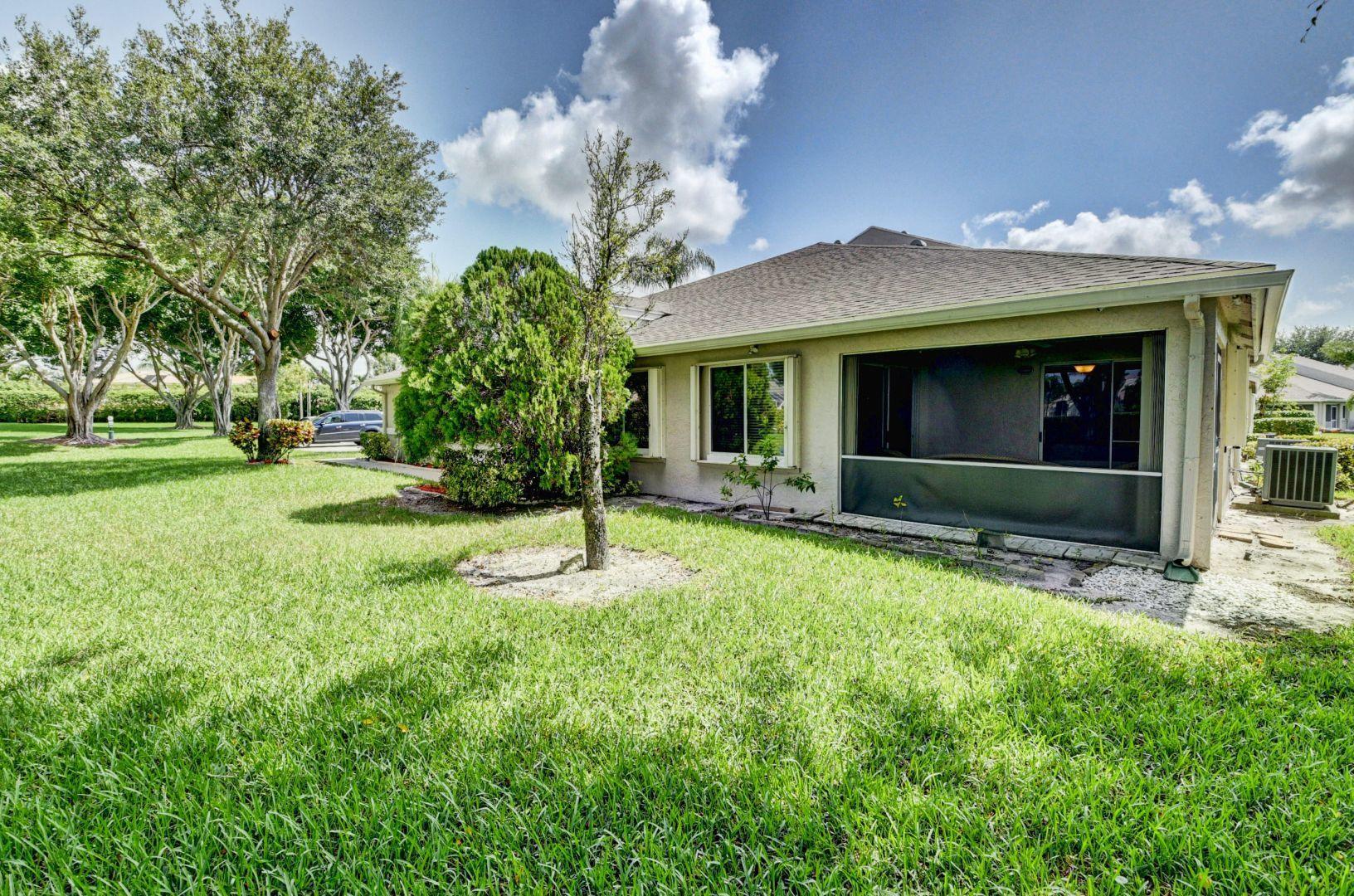 9238 Vineland Court, Unit G Boca Raton, FL 33496 - Photo 27 of 42 a front view of a house with a yard and garage